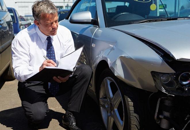 gray car with insurance policy parked on city street